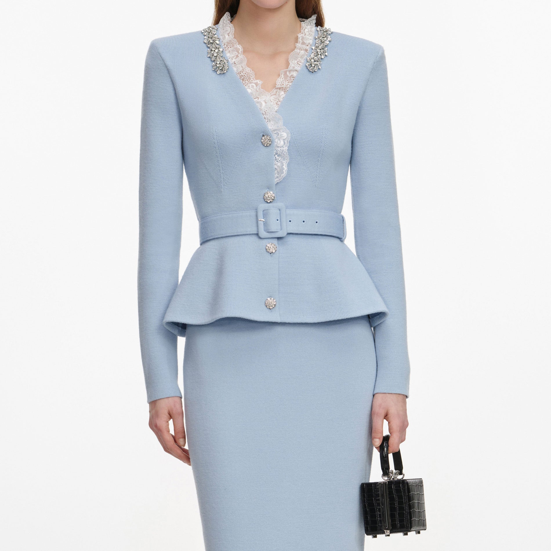 A close up of a woman wearing the Blue Crystal Trim Knit Midi Dress