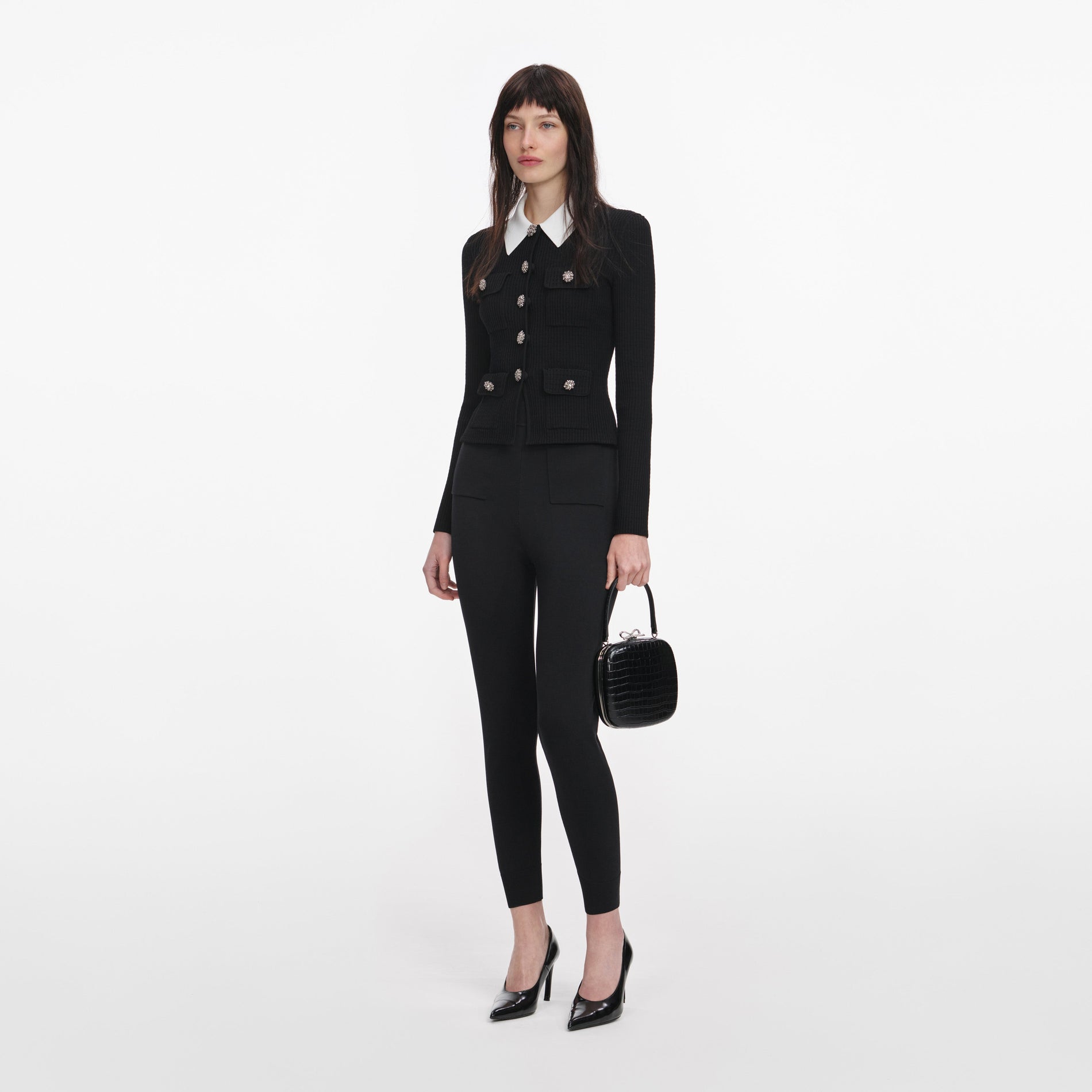 Side view of a woman wearing the Black Tailored Knit Top