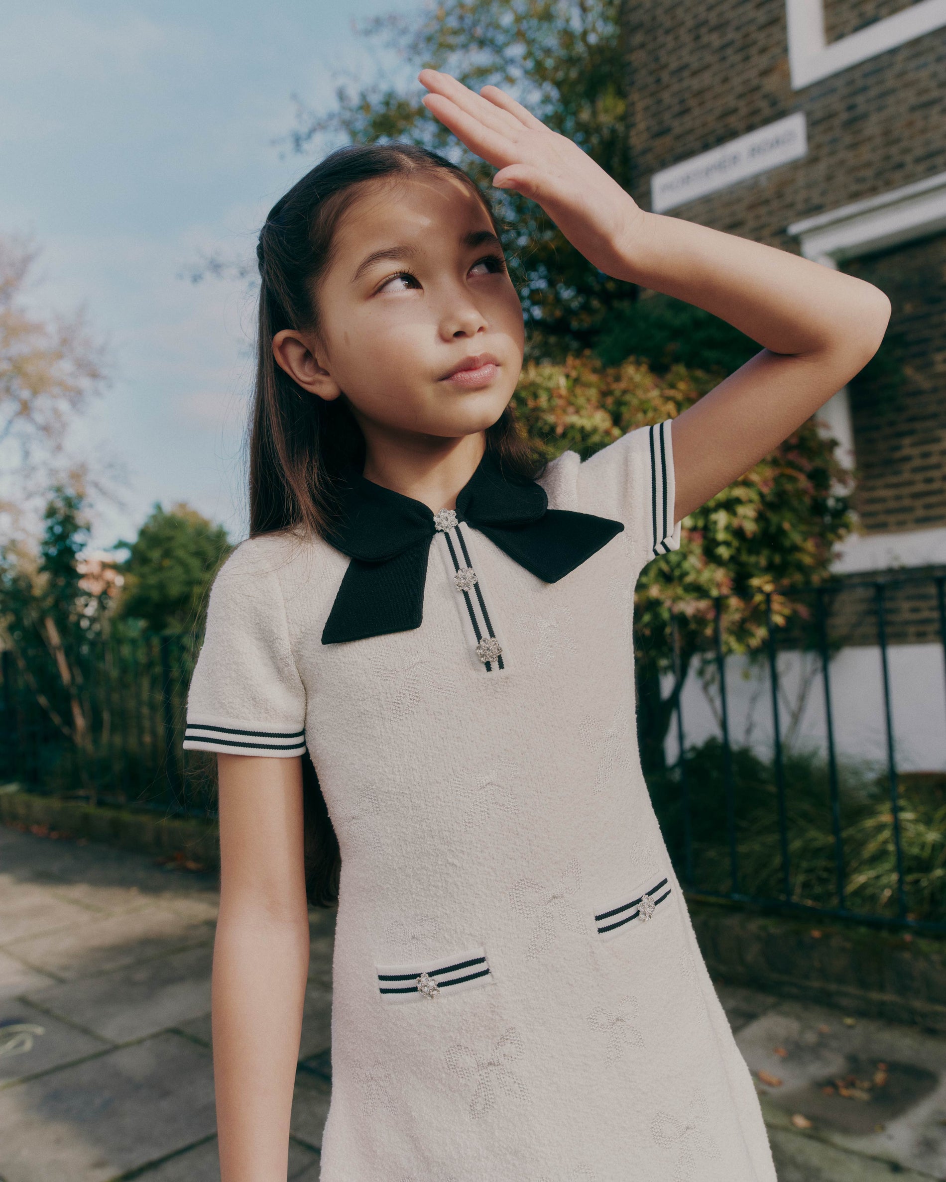 A close up of a woman wearing the White Jacquard Knit Dress