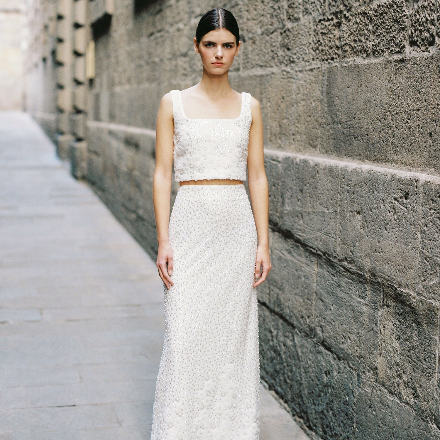 A woman wearing the White Beaded Sequin Maxi Skirt