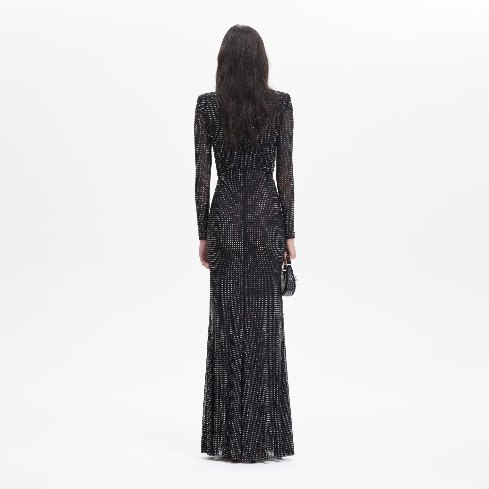 A woman wearing the Black Rhinestone Mesh Long Sleeve Maxi Dress