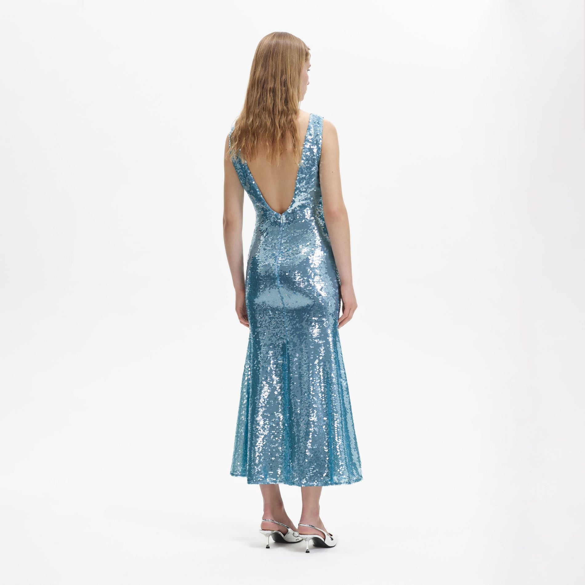 A woman wearing the Blue Sequin V Neck Maxi Dress