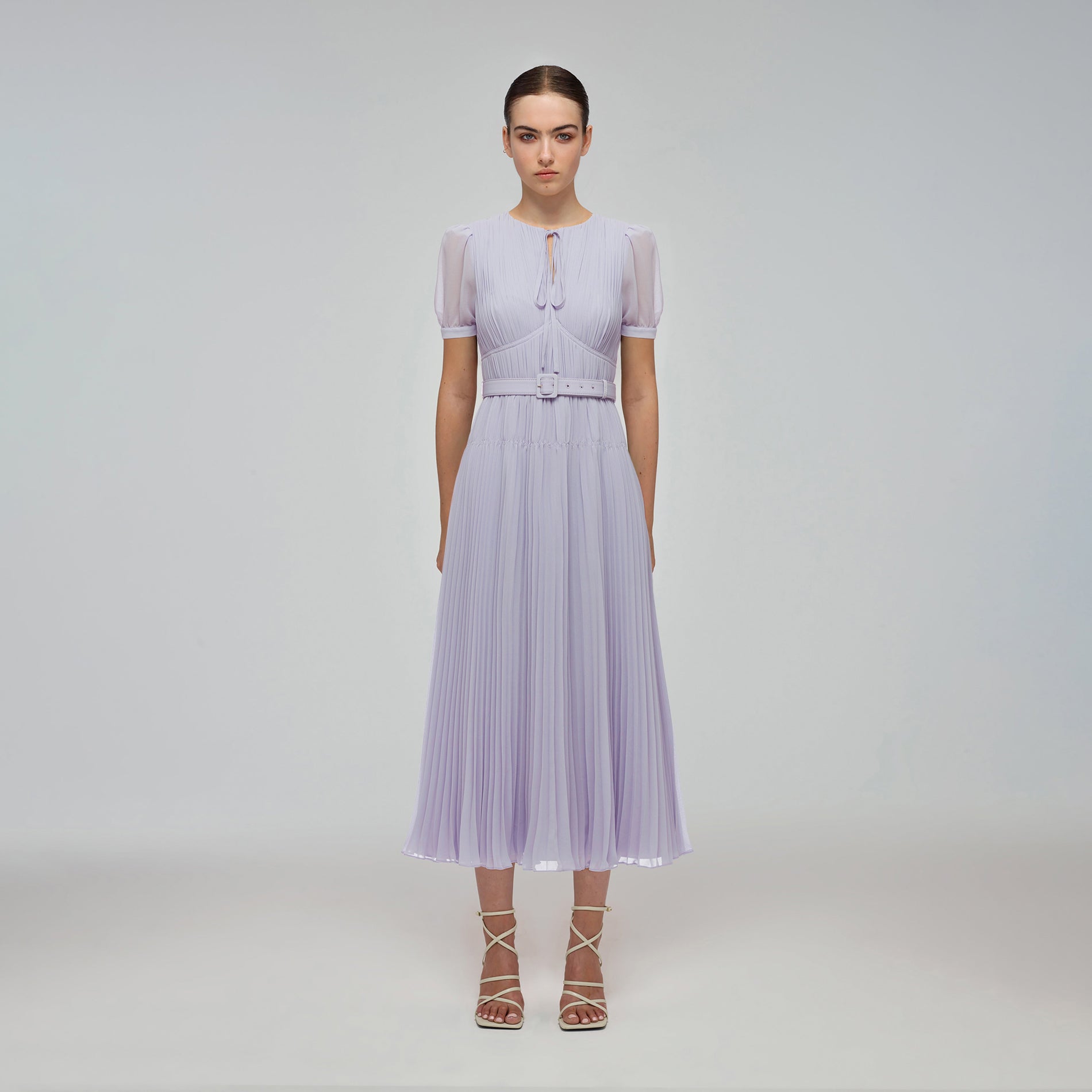 A woman wearing the Lilac Chiffon Midi Dress