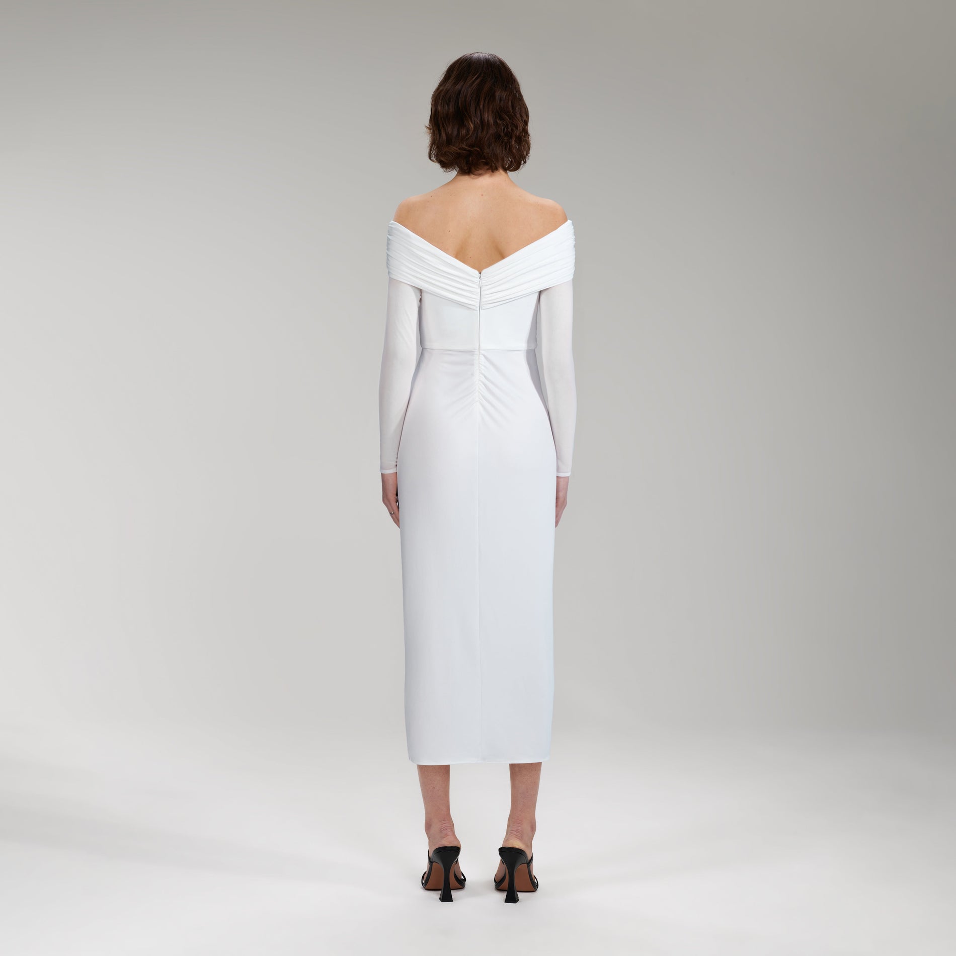 A woman wearing the White Jersey Crossover Bust Midi Dress