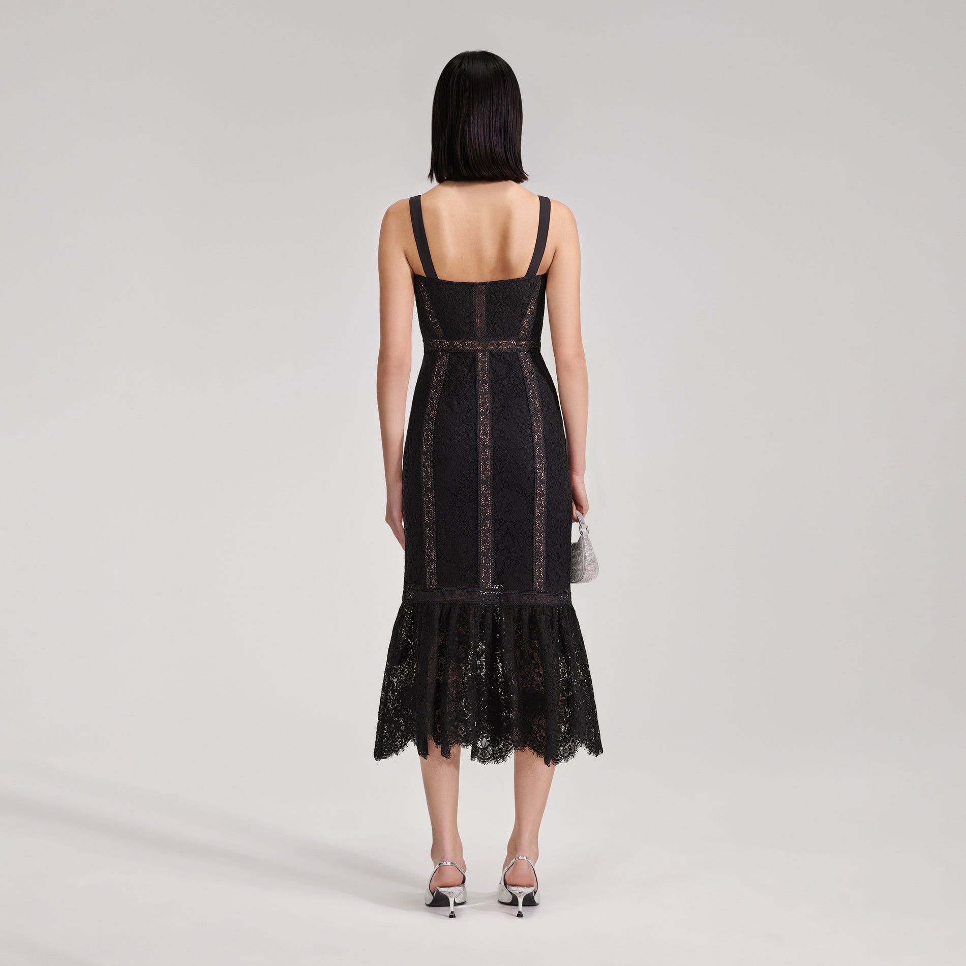 A woman wearing the Black Cord Lace Insert Midi Dress
