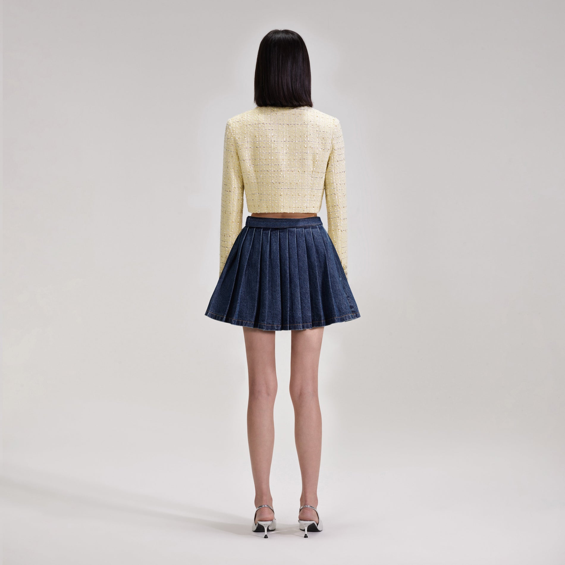 A woman wearing the Yellow Boucle Cropped Jacket