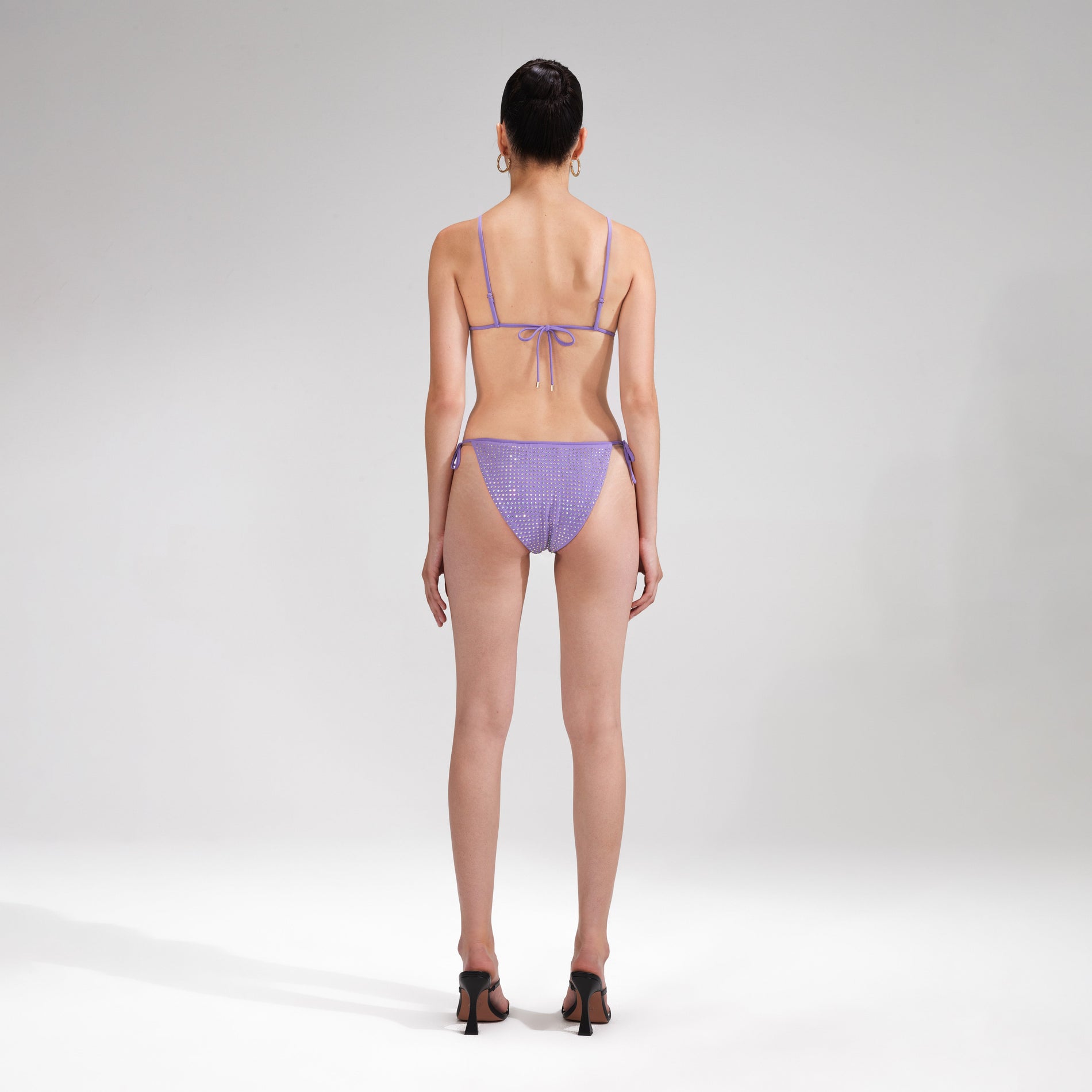 A woman wearing the Purple Rhinestone Bikini Brief