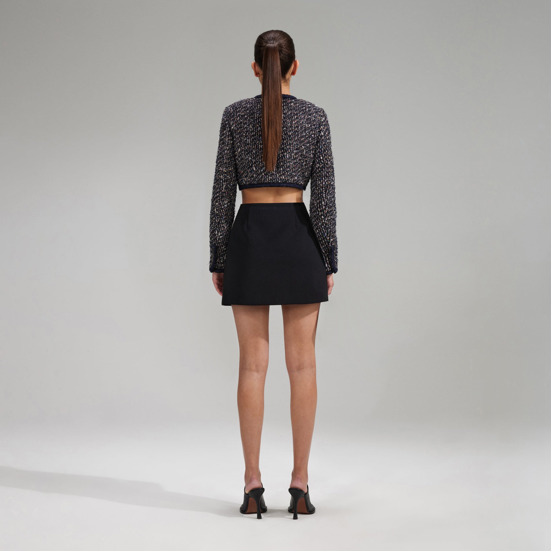 A woman wearing the Crop Boucle Jacket With Braid Detail