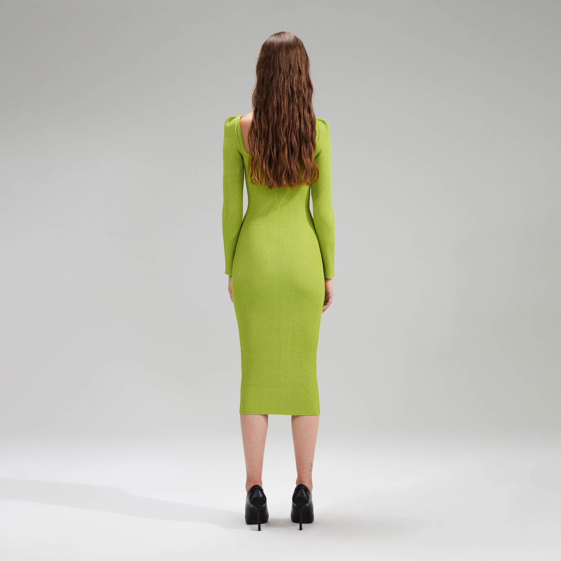 A woman wearing the Lime Green Lurex Knit Midi Dress