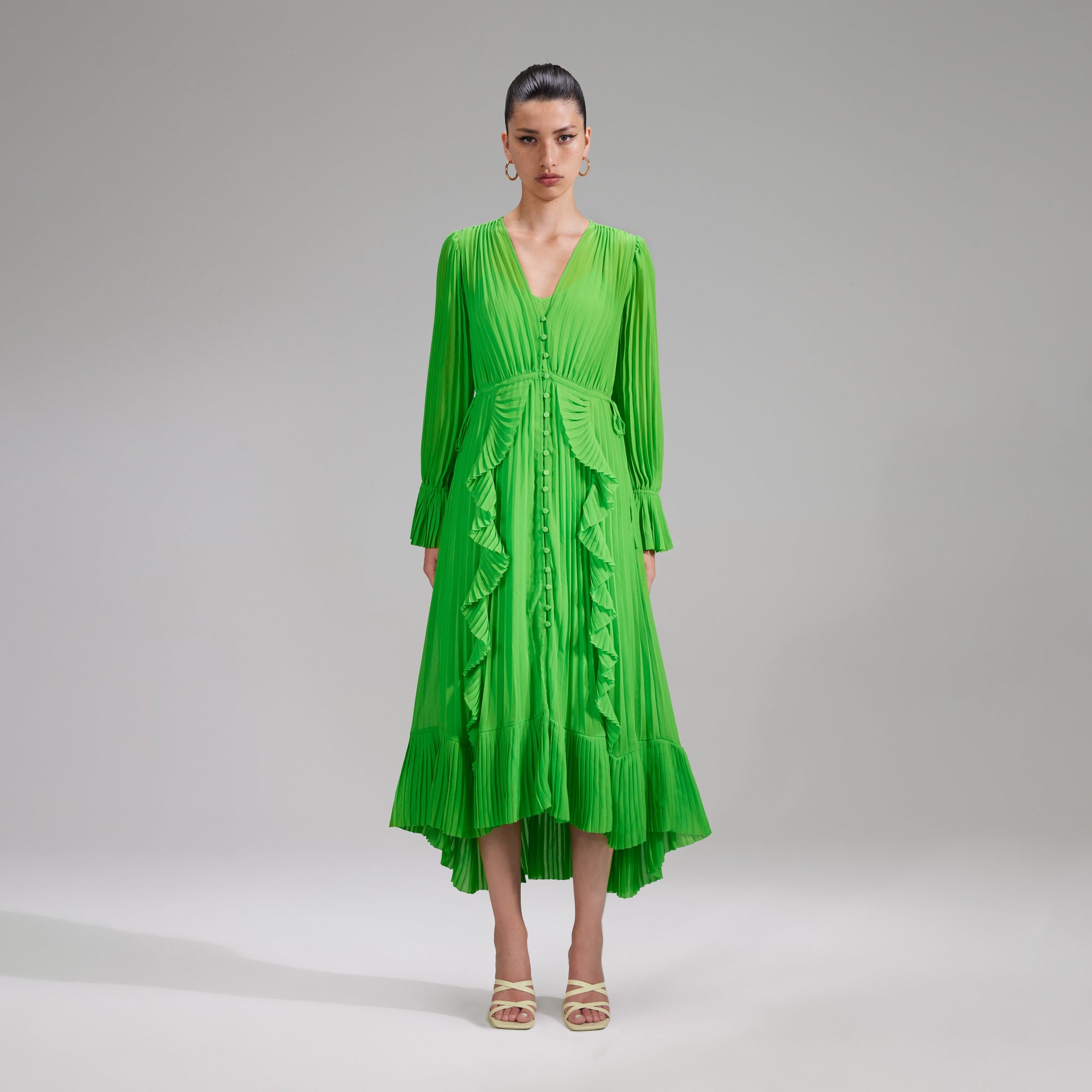 A woman wearing the Green Chiffon Ruffle Midi Dress