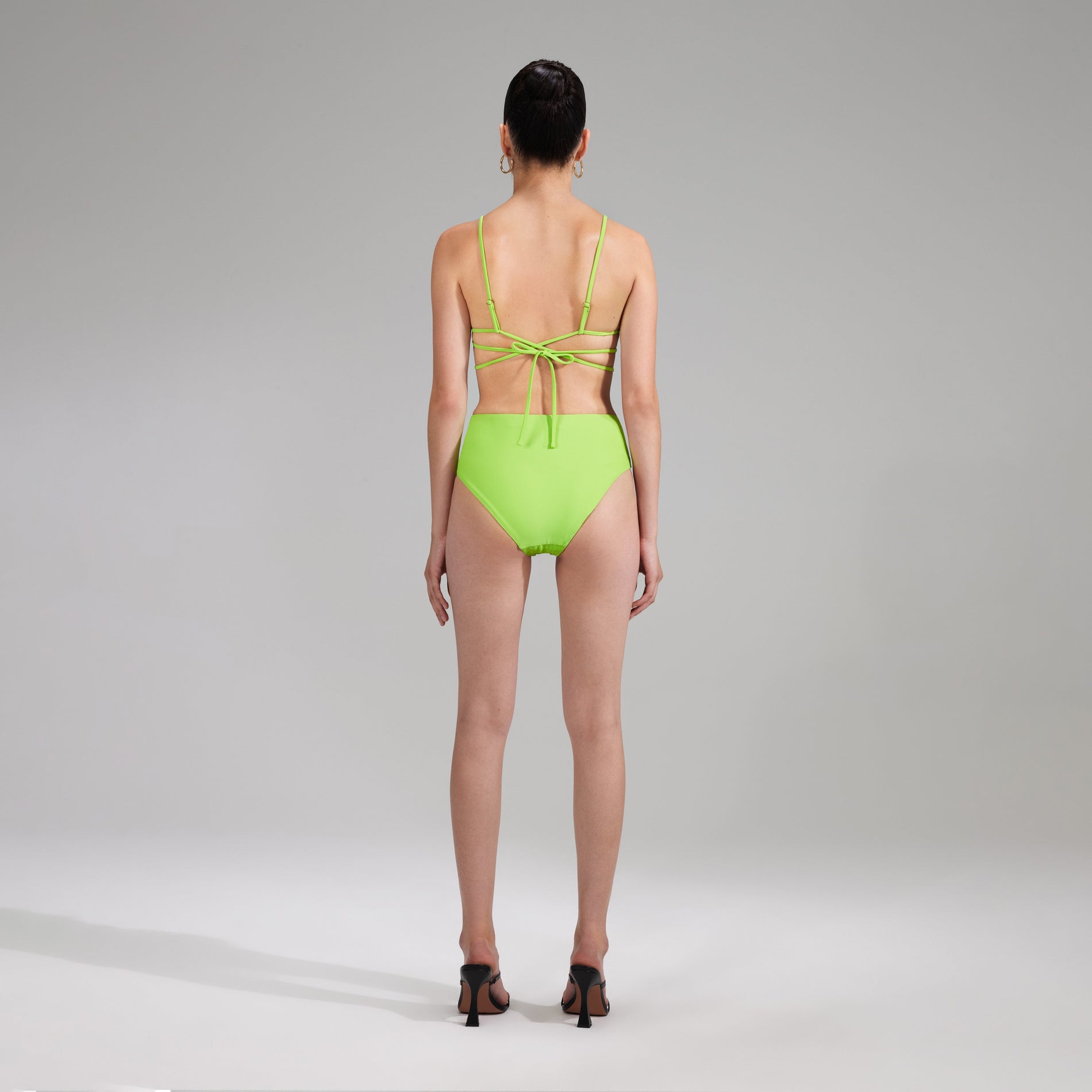 A woman wearing the Green High Waisted Bikini Brief