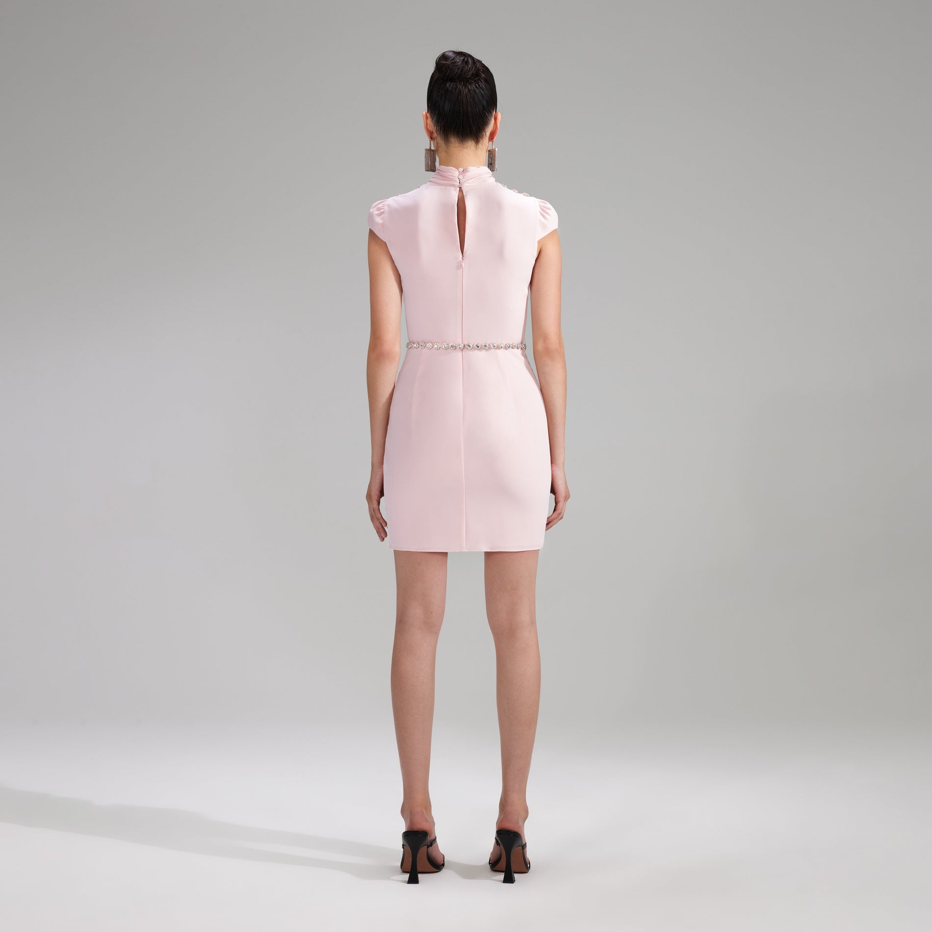 A woman wearing the Pink Stretch Crepe Ruched Mini Dress