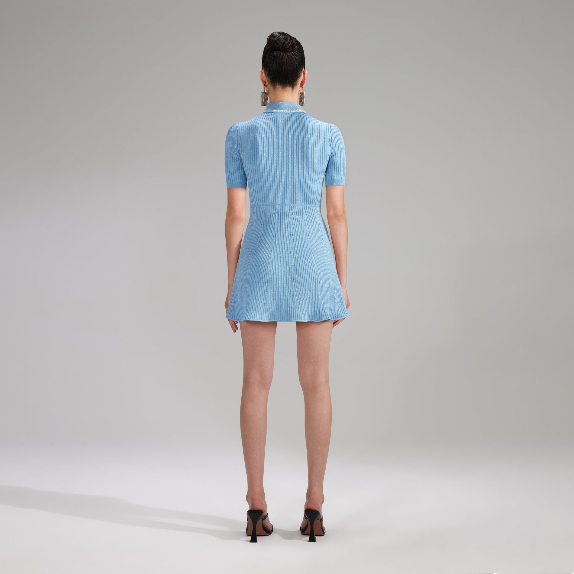 A woman wearing the Blue Lurex Diamante Knit Mini Dress