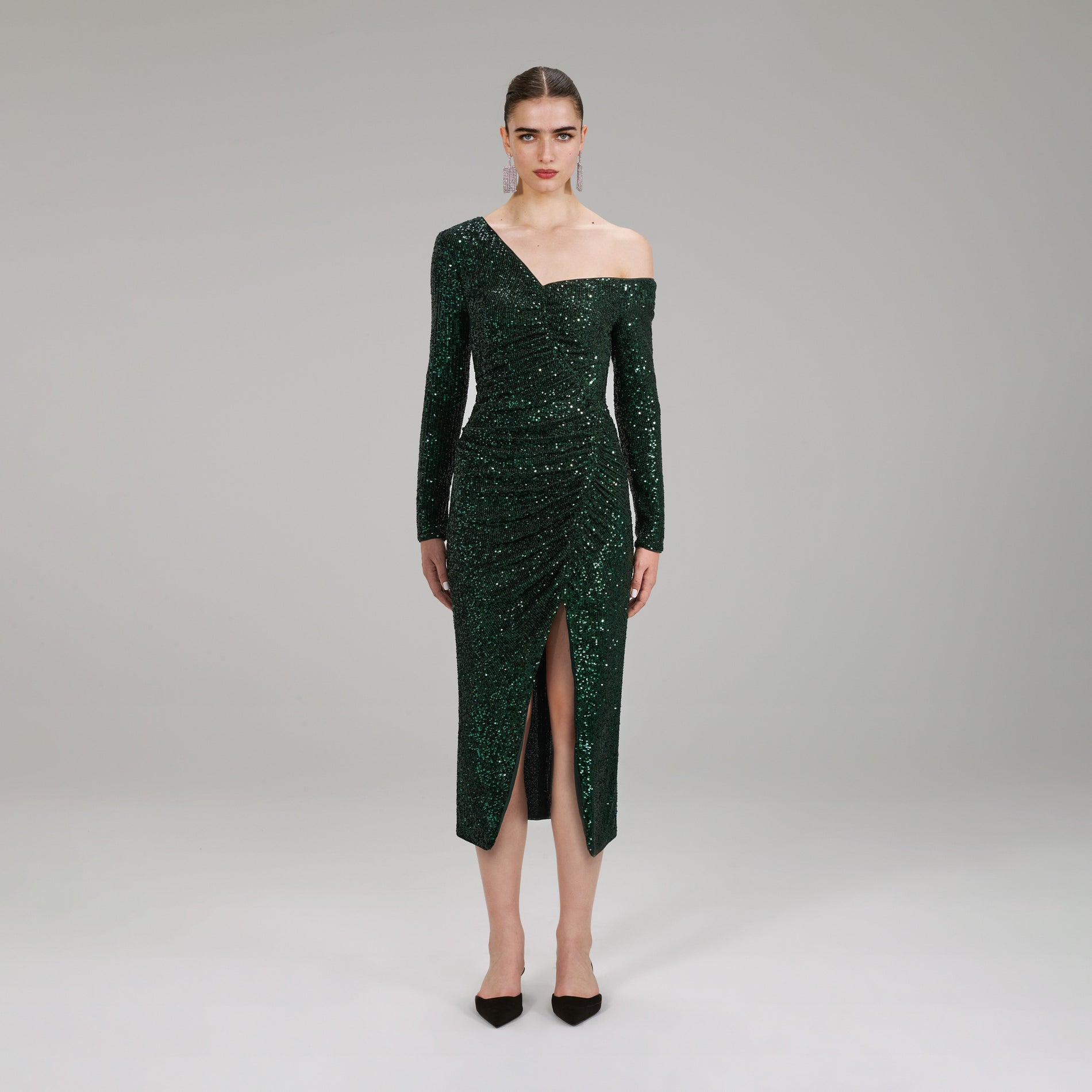 A woman wearing the Green Stretch Sequin Midi Dress