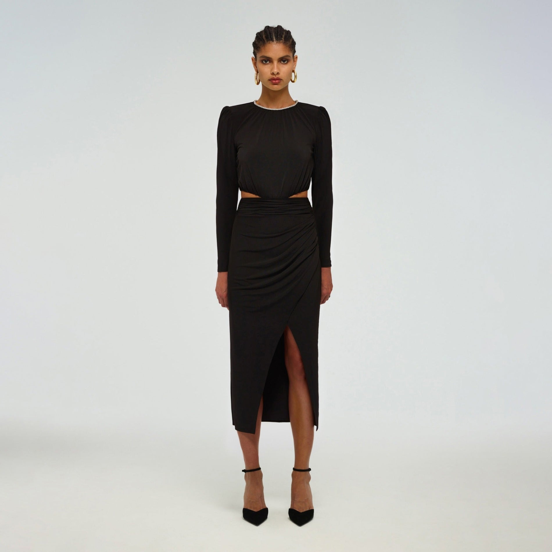 A woman wearing the Black Cut Out Midi Dress